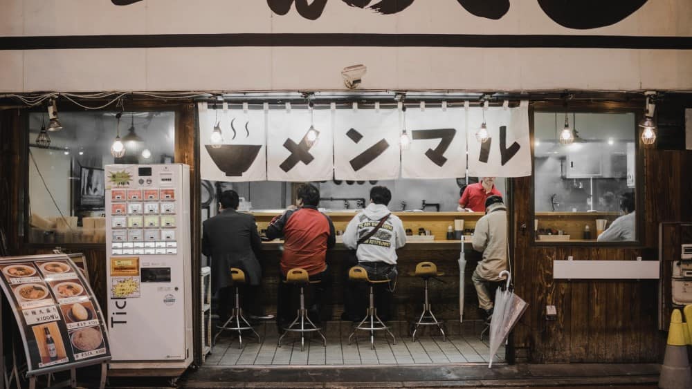 Japanese people eating casually at a food counter