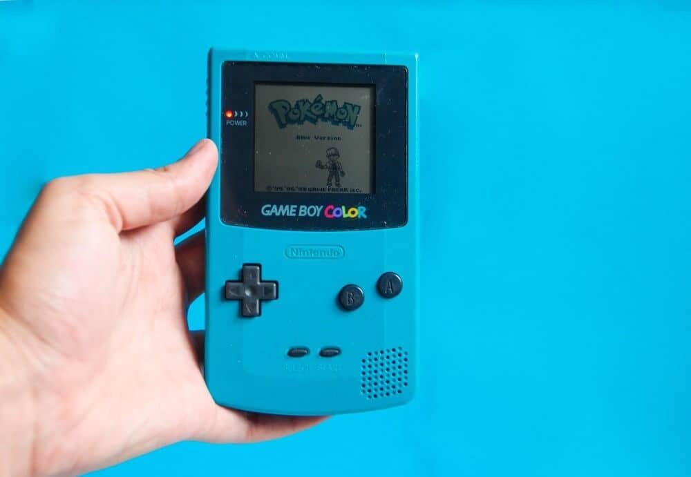 a Gameboy Colour with the Pokémon Blue starter screen