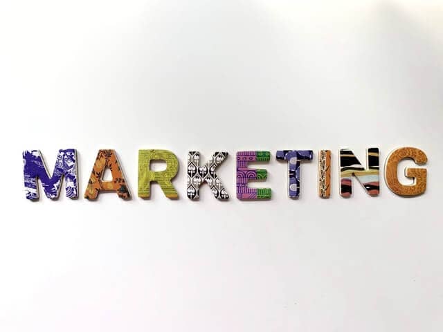 A colourful sign that says the word marketing on a white background.