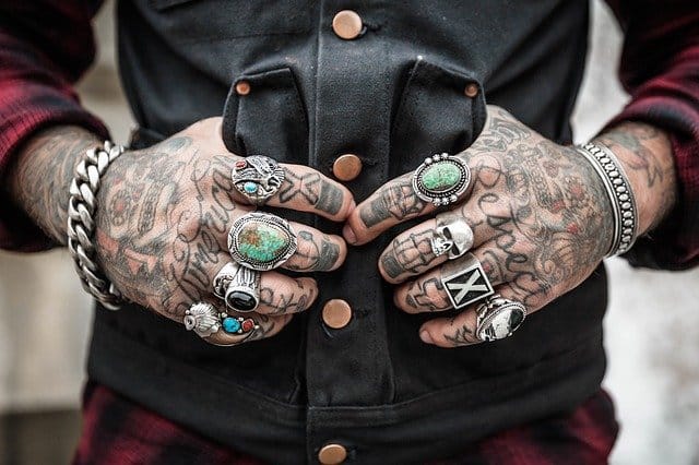 a man with tattoos on is hands