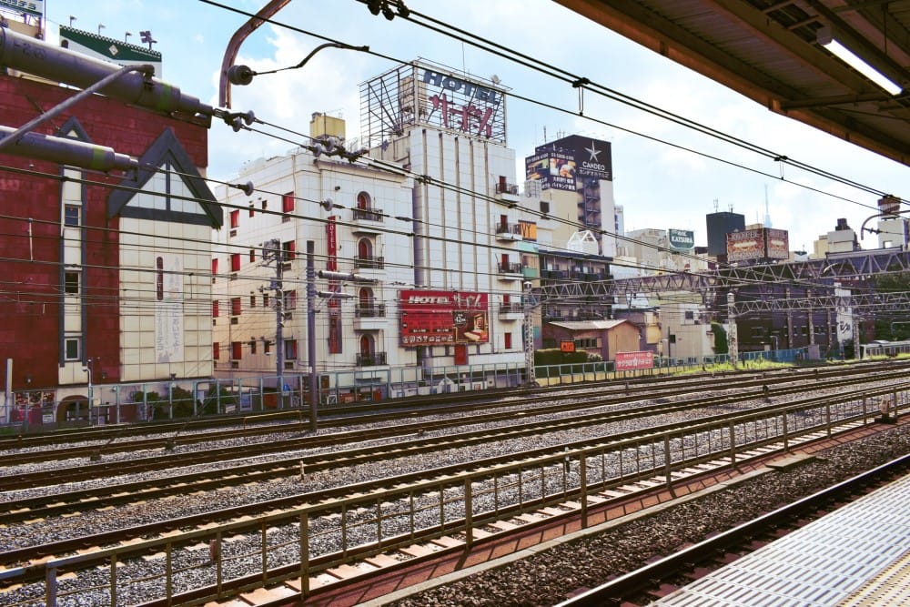 a Japanese railway line surrounded by city