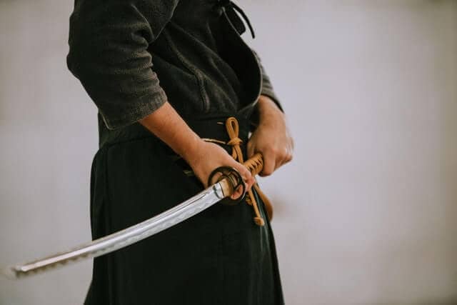 A samurai posing with his sword.