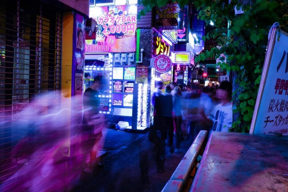 a neon-lit street in Tokyo at night