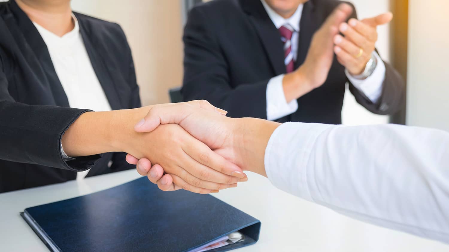 successful business team shaking hands with eachother in the office