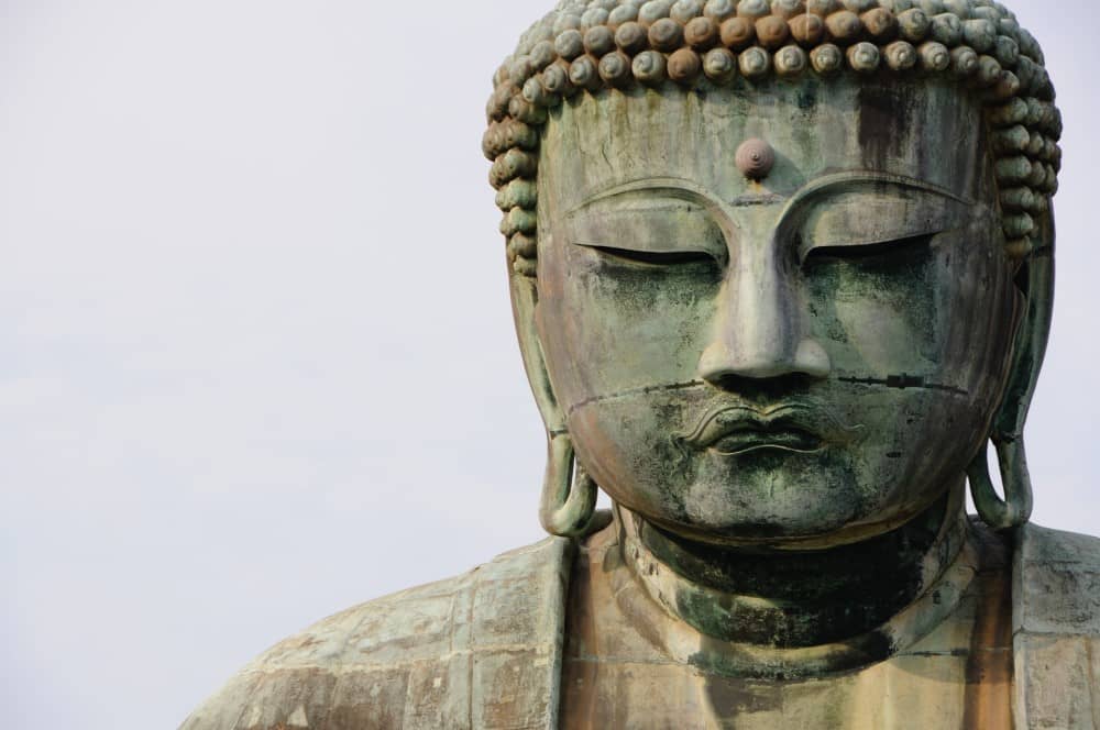a stone Buddha statue in Japan