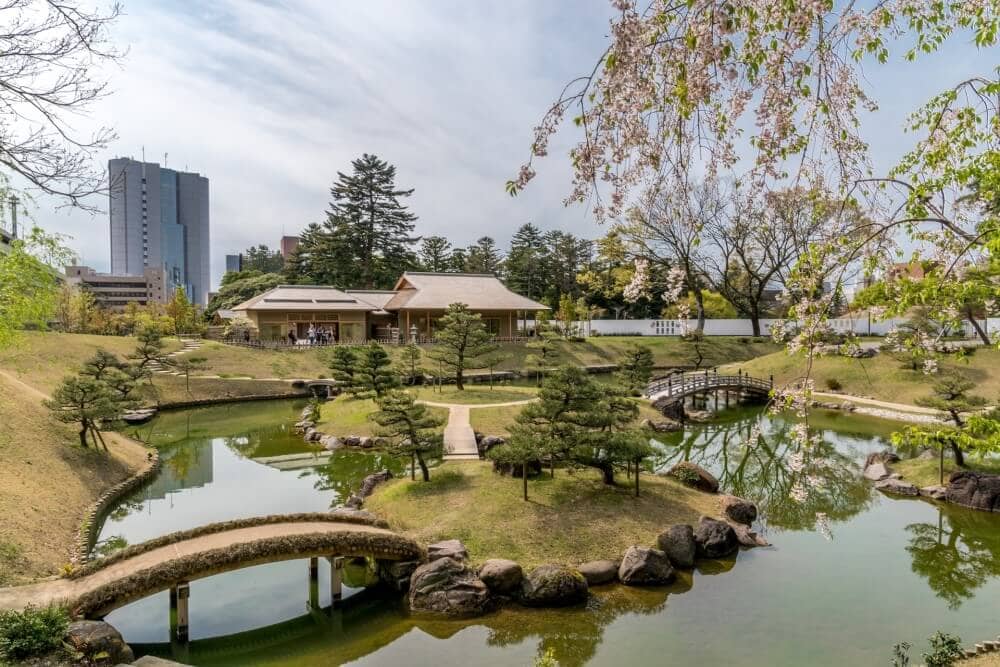 a garden in Kanazawa in front of the city