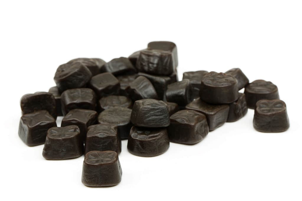 closeup of black licorice unsorted sweets isolated on white