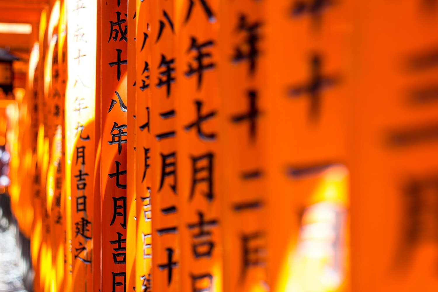 Close-up on engraved calligraphy on Japanese torii pillars