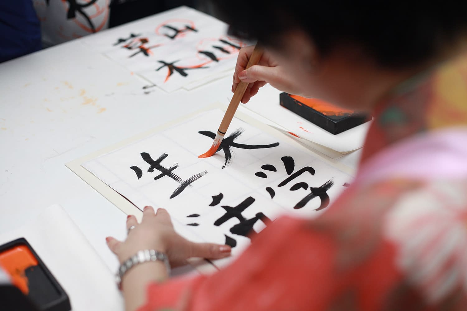 Lady performing Japanese calligraphy