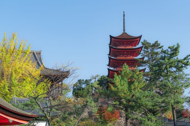 Japanese temple with green trees in the foreground