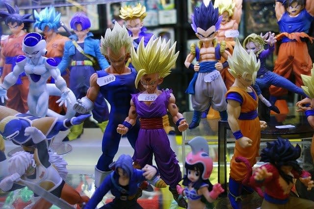 Dragon ball character toys in a glass cabinet.