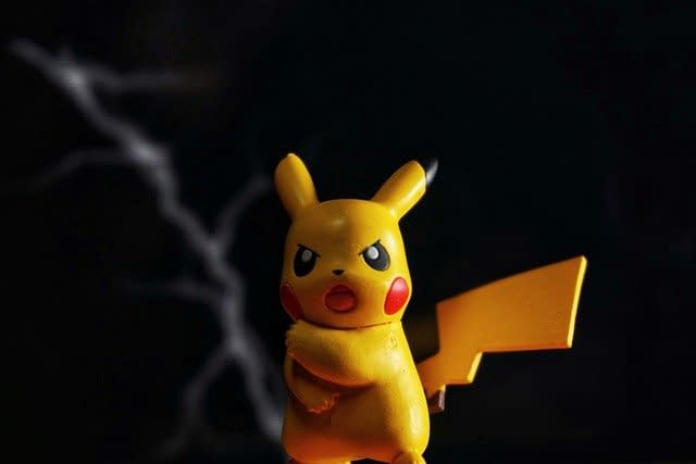 A Pikachu toy on a black background.