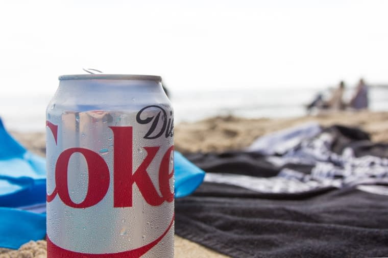 a can of diet coke with a beach in the background