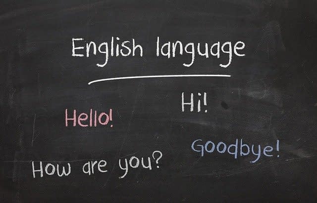 A blackboard with basic english phrases written on it.