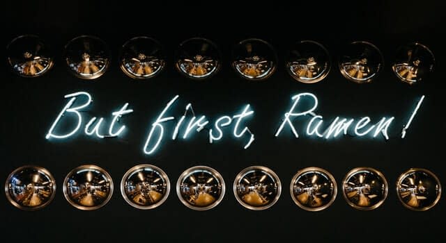 A neon sign that reads: “but first, Ramen!”