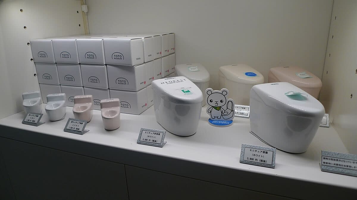 Cute toilet toys in a display cabinet.
