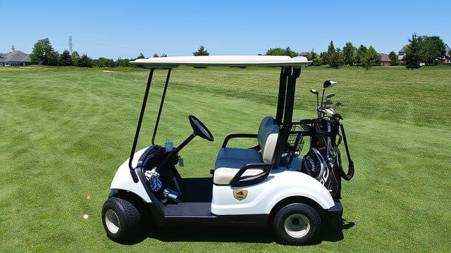 A golf cart on the fairway of a golf course
