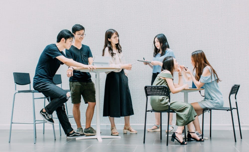japanese people working and chatting together in a canteen