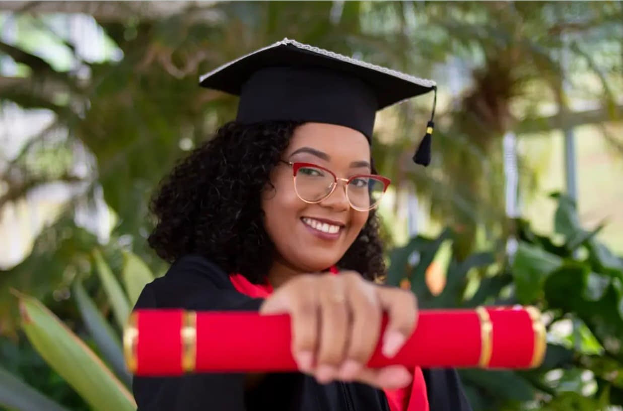 woman holding a degree certificate