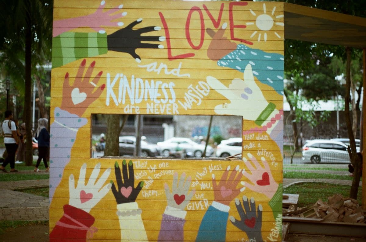 a piece of art showing words like love and kindness