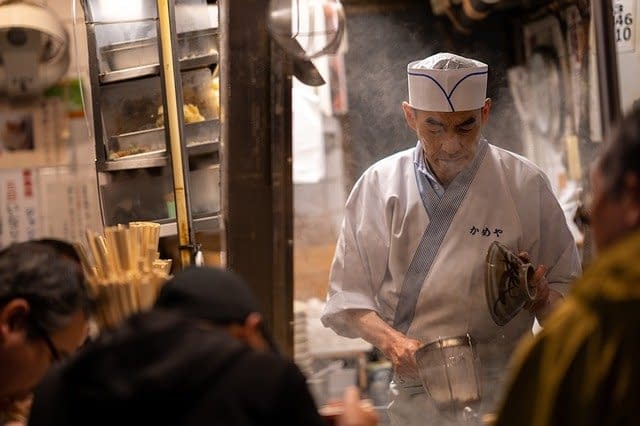 A Japanese street food vendor preparing food.
