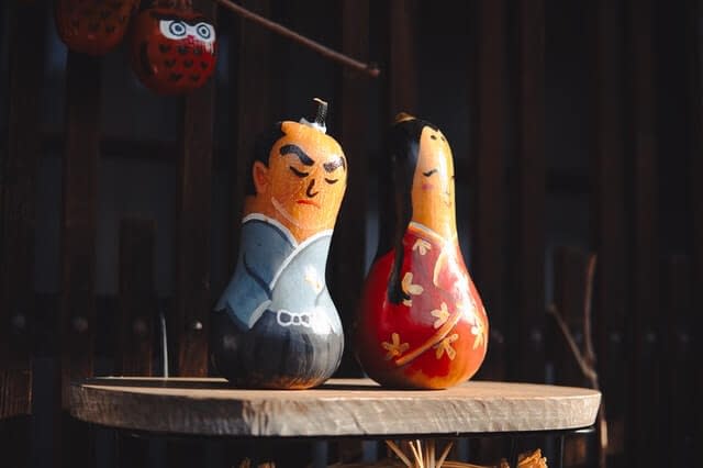 Traditional Japanese style toys on top of a wooden table.