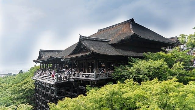 Tourists standing on the main veranda at Kiyomizu-dera Temple