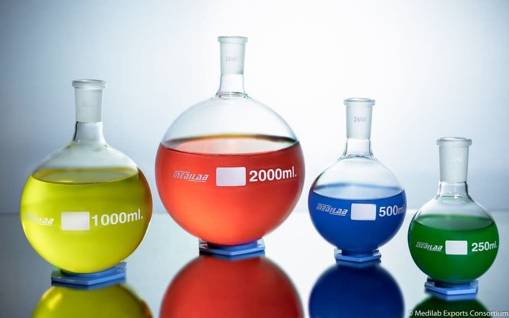 bottles of coloured fluid in science flasks