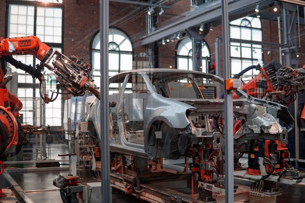 Manufacturing robots work on assembling a car.