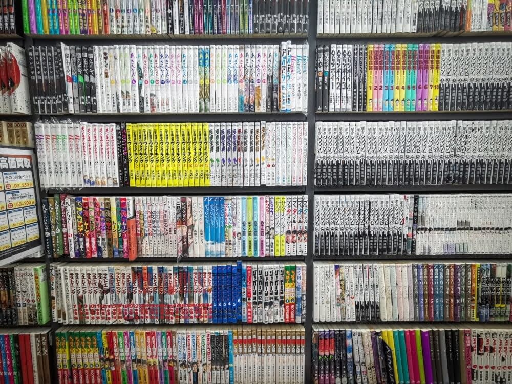 a bookshelf full of manga comics