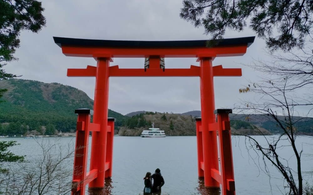 people looking at a view through a torii gate