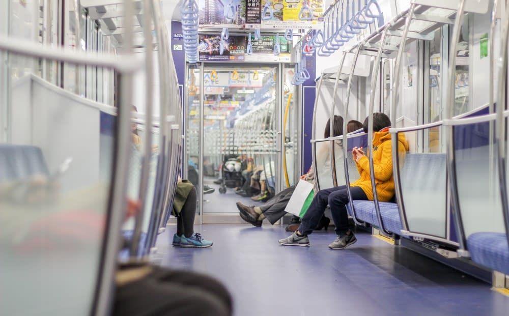 people-using-phone-on-train