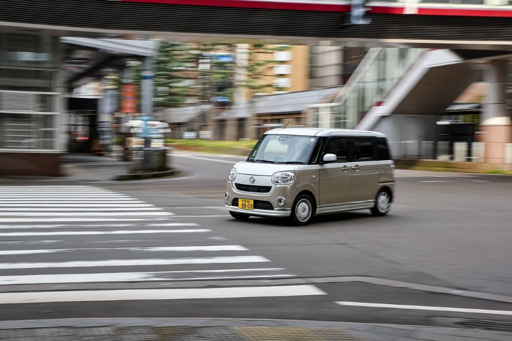 silver japanese k car turning a corner