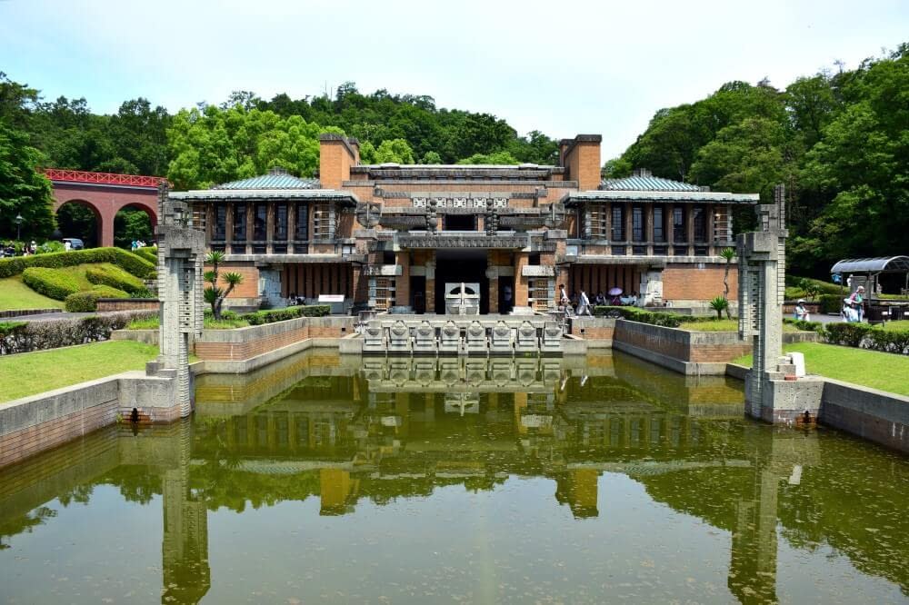 a Japanese building with a pond