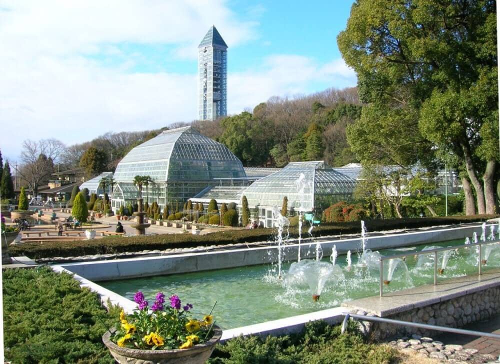 a glasshouse surrounded by gardens