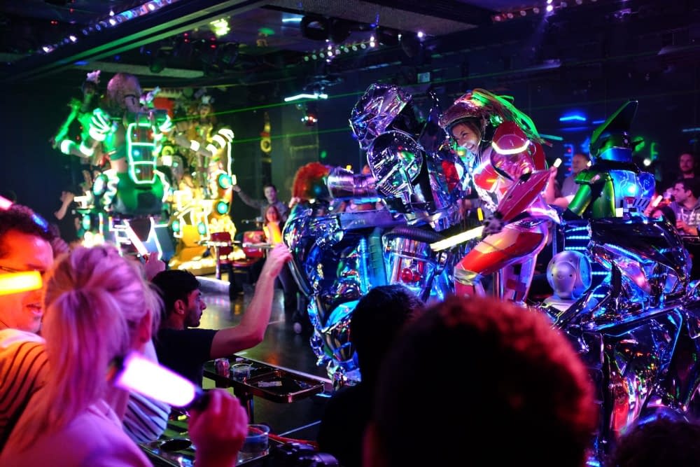 An audience enjoying eccentric entertainment at a robot cafe in Tokyo.