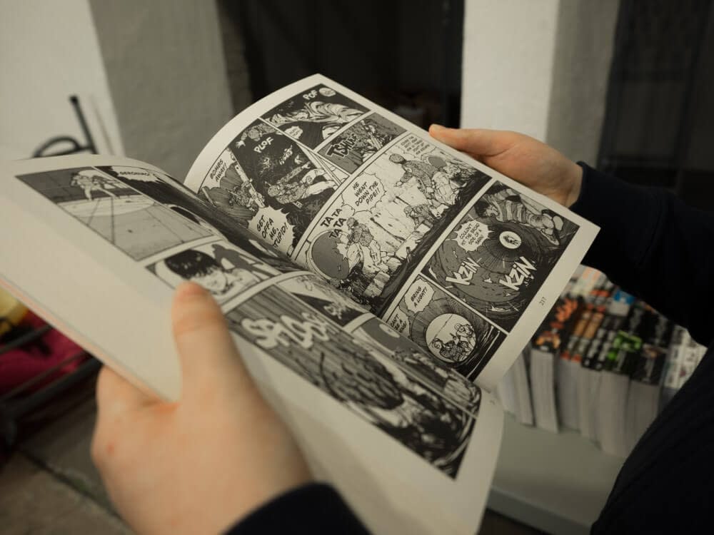 a person reading a manga comic
