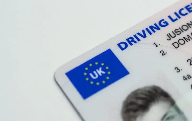 A UK diving licence resting on a white table.