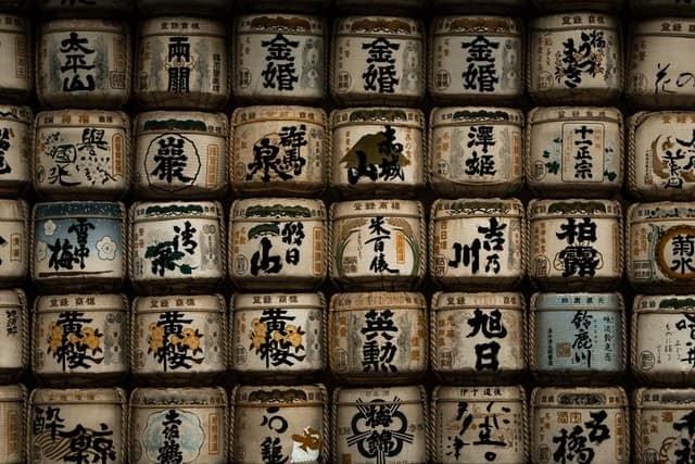 Sake containers piled up against a wall.